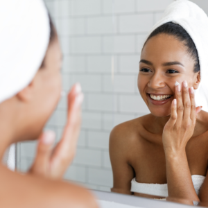 Woman putting on face cream